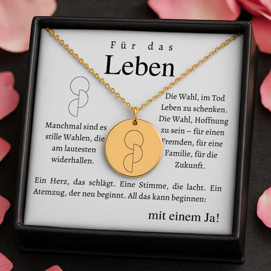 Halskette mit runden Anhänger aus Edelstahl in 18k Gelb Gold, fein graviertes Blättchen-Symbol für Organspende. Personalisierbare Gravur auf der Rückseite. Verstellbare Kette in Stahlsilber, 18K vergoldet oder rosé vergoldet. Inklusive Grußkarte mit symbolischem Text zur Organspende. Ideal als Danke schön Geschenk, Mutmacher oder Symbol für Leben retten.